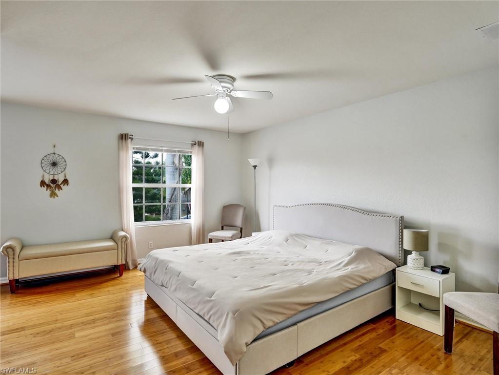 2941 Inlet Cove Lane East Naples, FL 34120 - Photo 36 of 50 a bedroom with a bed and a chair