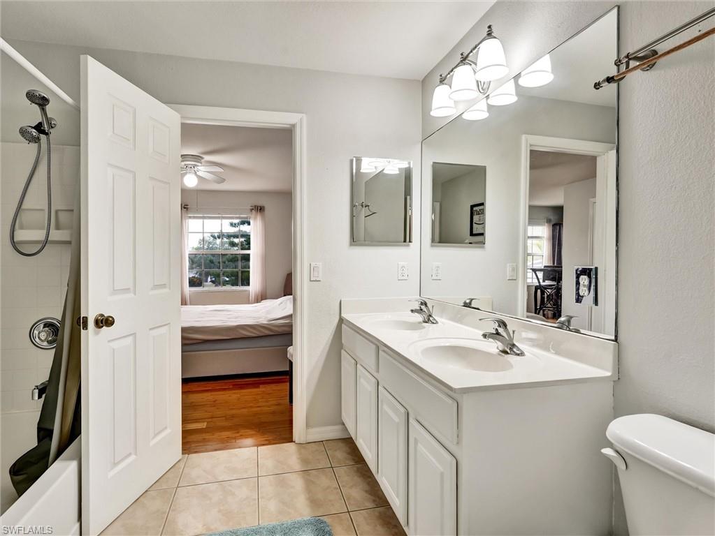 2941 Inlet Cove Lane East Naples, FL 34120 - Photo 40 of 50 a bathroom with a sink a toilet a mirror and shower