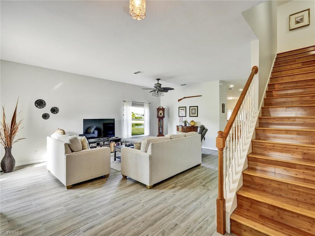 2941 Inlet Cove Lane East Naples, FL 34120 - Photo 4 of 50 a living room with furniture and a fireplace