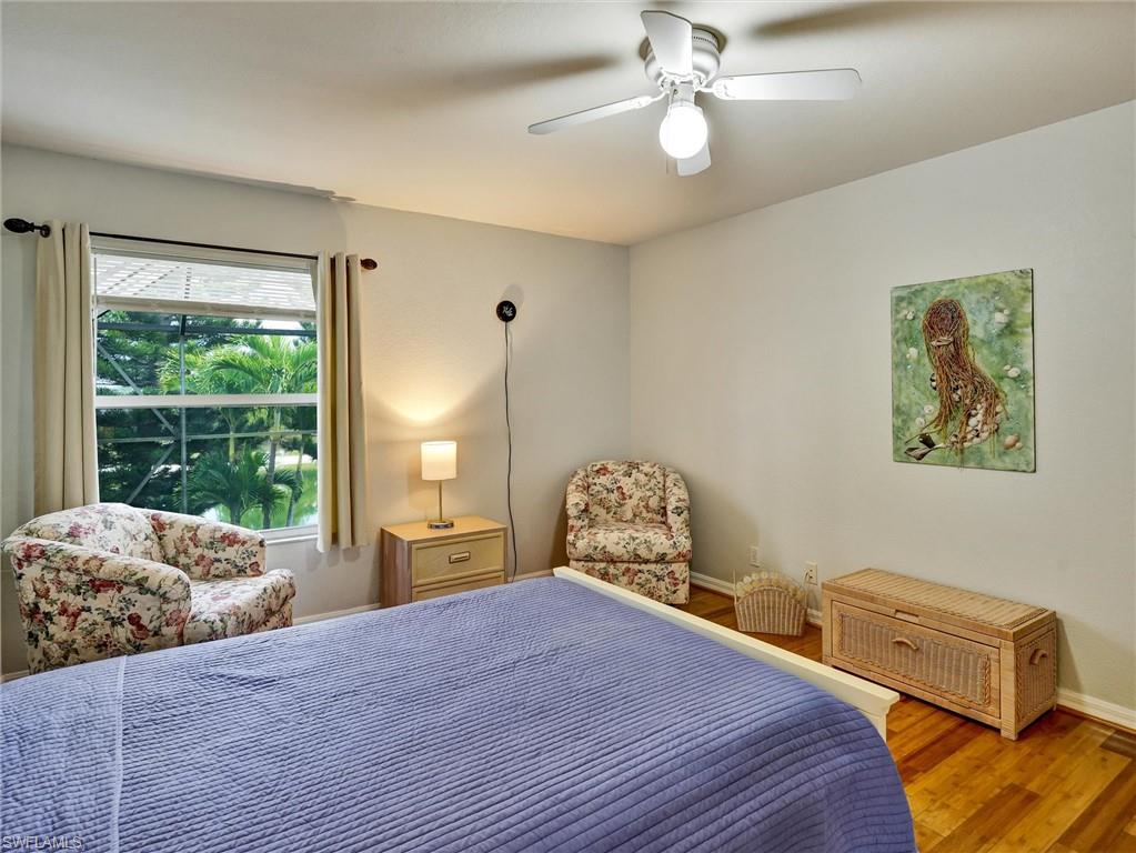 2941 Inlet Cove Lane East Naples, FL 34120 - Photo 42 of 50 a bedroom with a bed dresser and a window