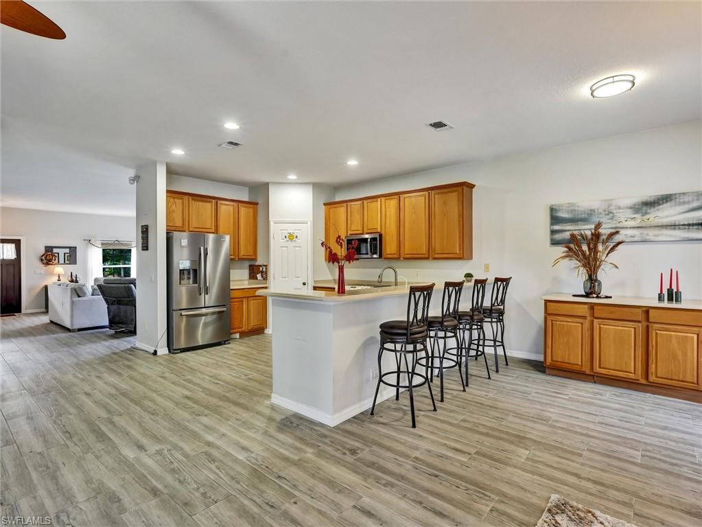 2941 Inlet Cove Lane East Naples, FL 34120 - Photo 8 of 50 a living room with furniture and kitchen view