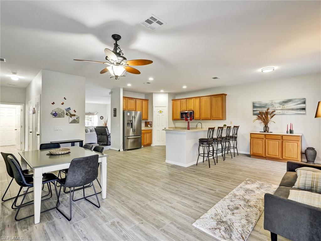 2941 Inlet Cove Lane East Naples, FL 34120 - Photo 10 of 50 a view of a dining room with furniture and wooden floor