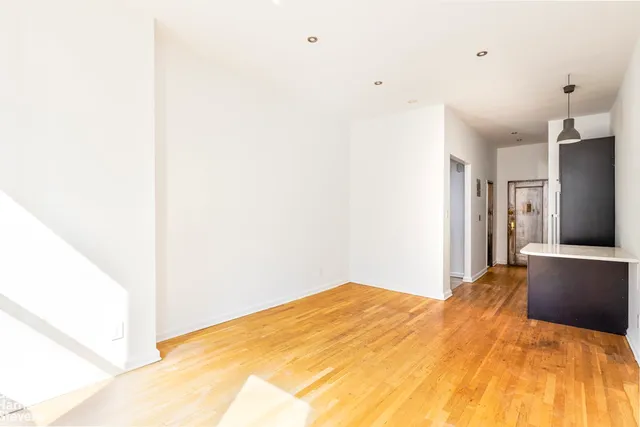 a bedroom with furniture and a wooden floor