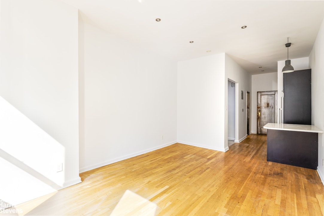 435 East 85th Street, Unit 4C Manhattan, NY 10028 - Photo 4 of 9 a bedroom with a bed and a chandelier