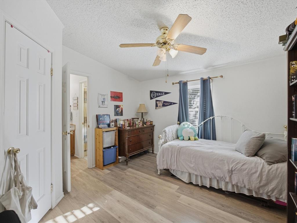 3275 Finis Road Graham, TX 76450 - Photo 24 of 36 a bedroom with a bed and ceiling fan