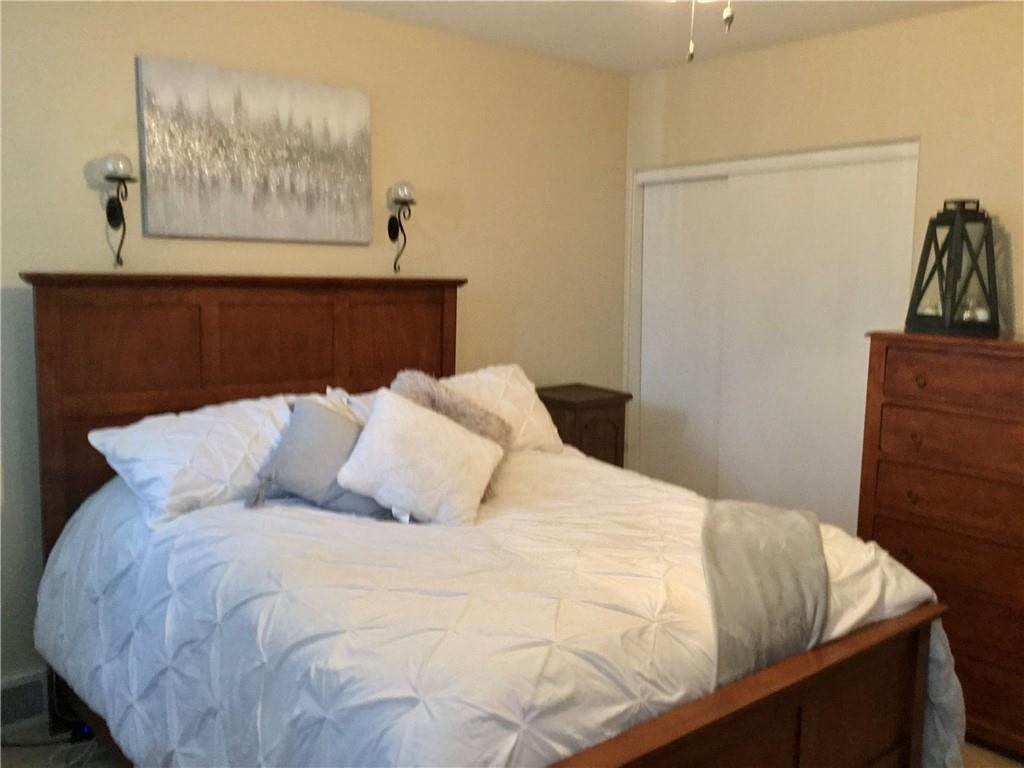 104 Sumner Avenue Vandergrift, PA 15690 - Photo 14 of 26 a large bed sitting in a bedroom next to a cabinet