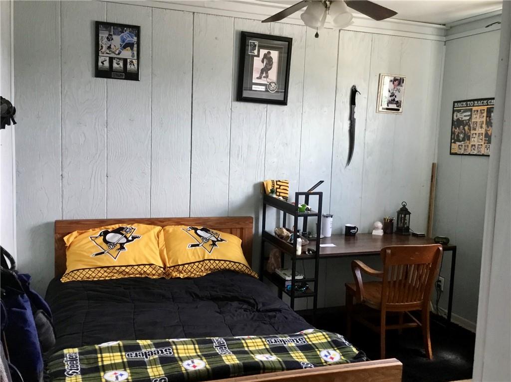 104 Sumner Avenue Vandergrift, PA 15690 - Photo 19 of 26 a bedroom with a bed and a table in it