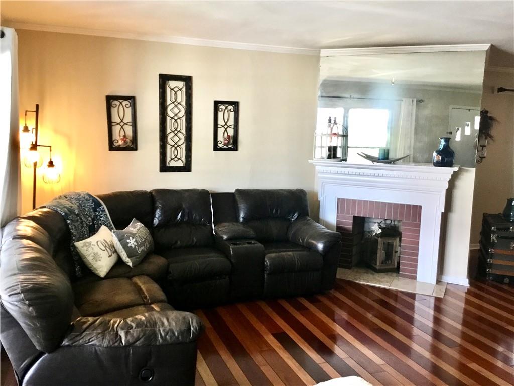 104 Sumner Avenue Vandergrift, PA 15690 - Photo 5 of 26 a living room with furniture and a fireplace