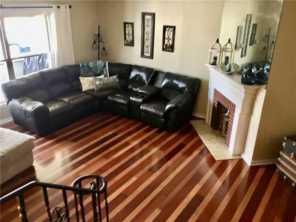 104 Sumner Avenue Vandergrift, PA 15690 - Photo 6 of 26 a living room with furniture and a fireplace