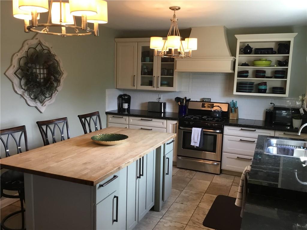 104 Sumner Avenue Vandergrift, PA 15690 - Photo 10 of 26 a kitchen with a stove and a kitchen island