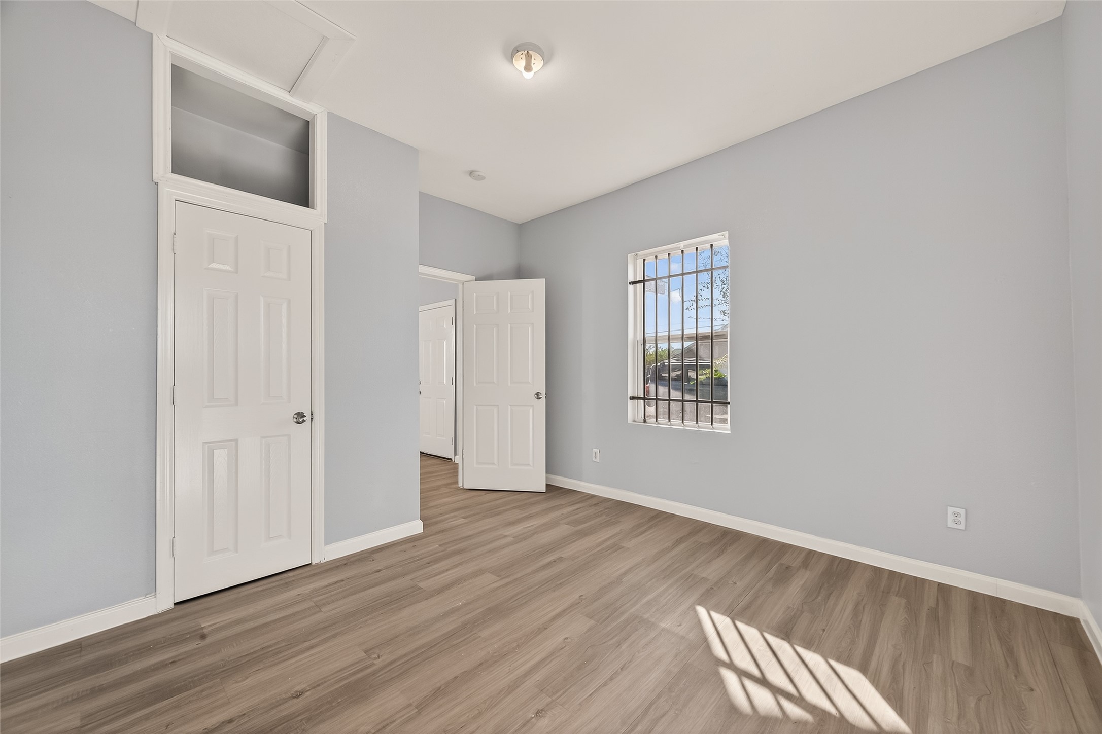 8211 Parnell Street Houston, TX 77051 - Photo 19 of 22 an empty room with wooden floor and windows