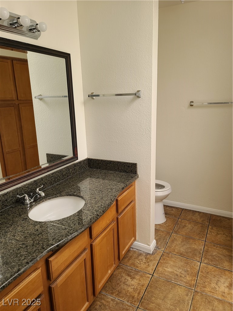 9325 West Desert Inn Road, Unit 233 Las Vegas, NV 89117 - Photo 6 of 10 Bathroom with vanity, tile patterned flooring, and a textured wall