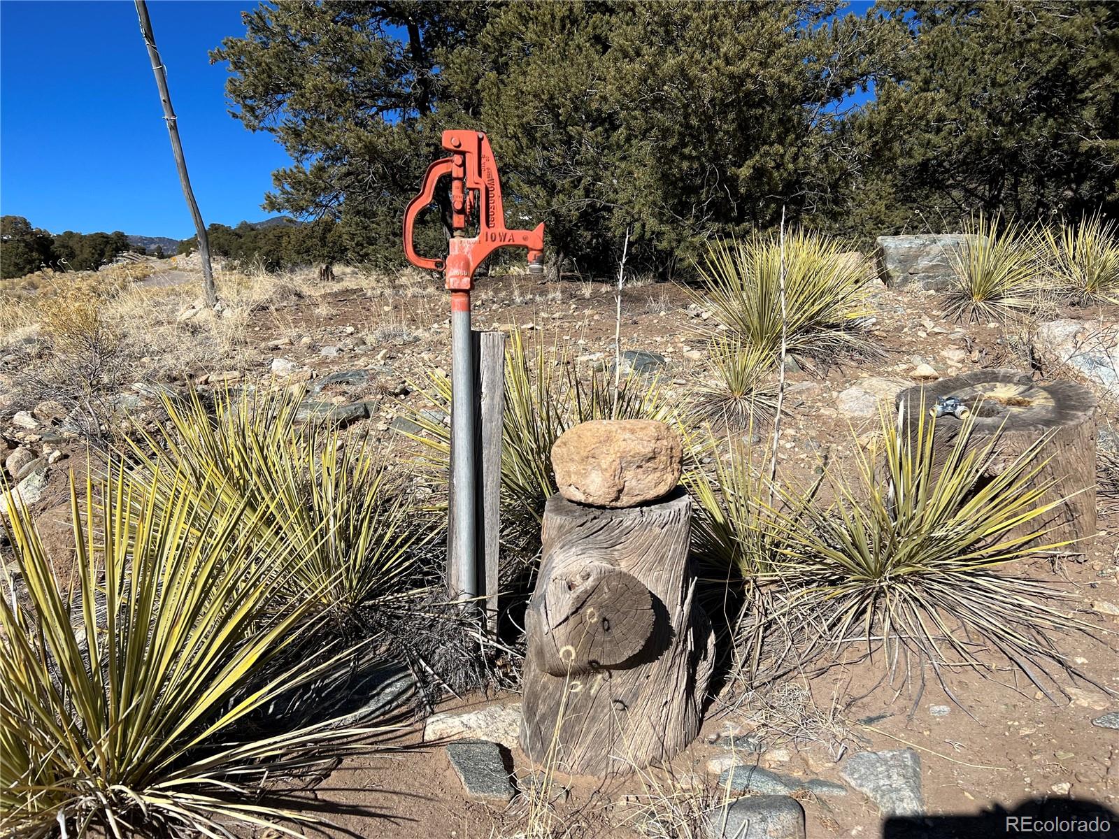 Naropa Tract Crestone, CO 81131 - Photo 20 of 22 a backyard of a house with table and chairs