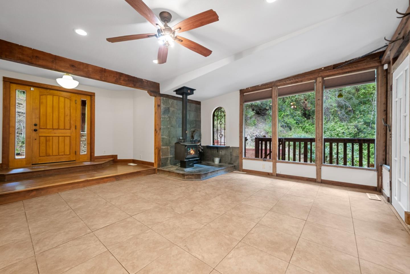 975 Logan Creek Road Boulder Creek, CA 95006 - Photo 17 of 41 a view of a livingroom with a ceiling fan and window