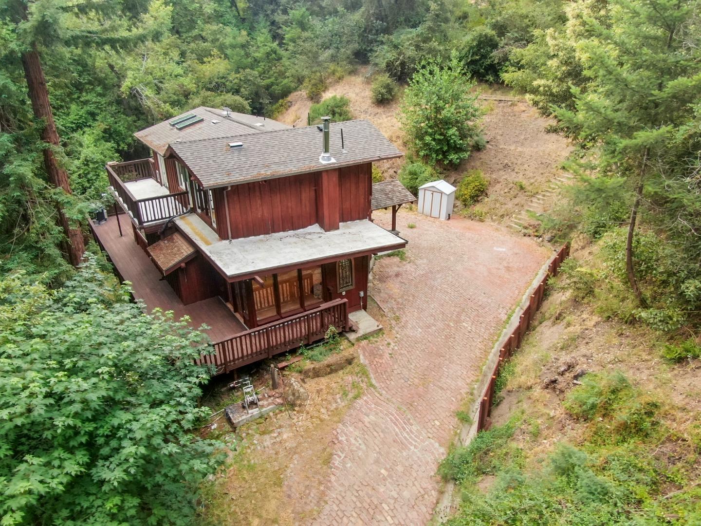 975 Logan Creek Road Boulder Creek, CA 95006 - Photo 2 of 41 an aerial view of a house with swimming pool and large trees