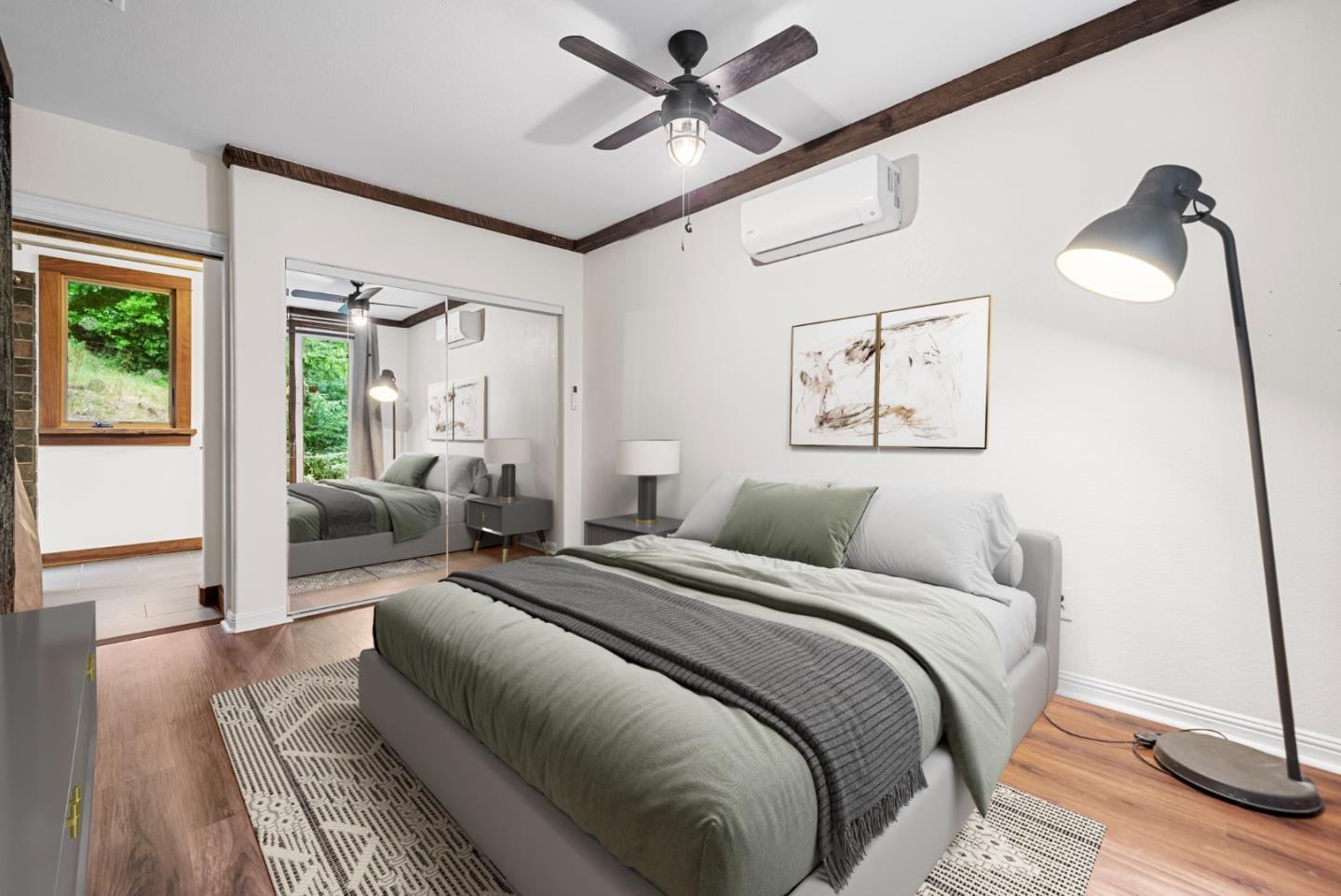 975 Logan Creek Road Boulder Creek, CA 95006 - Photo 34 of 41 a bedroom with a large bed and wooden floor