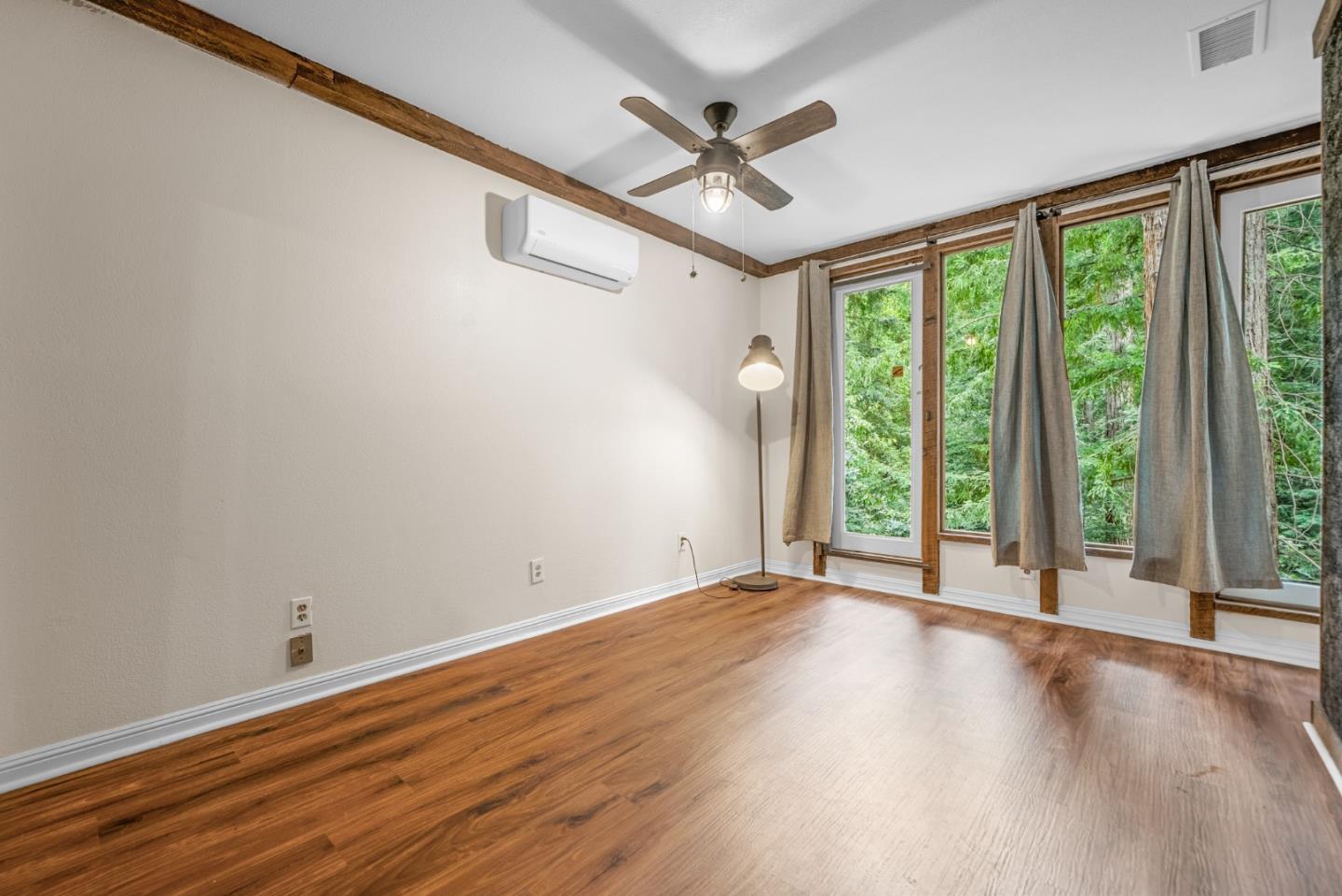975 Logan Creek Road Boulder Creek, CA 95006 - Photo 35 of 41 a view of an empty room with a window and wooden floor