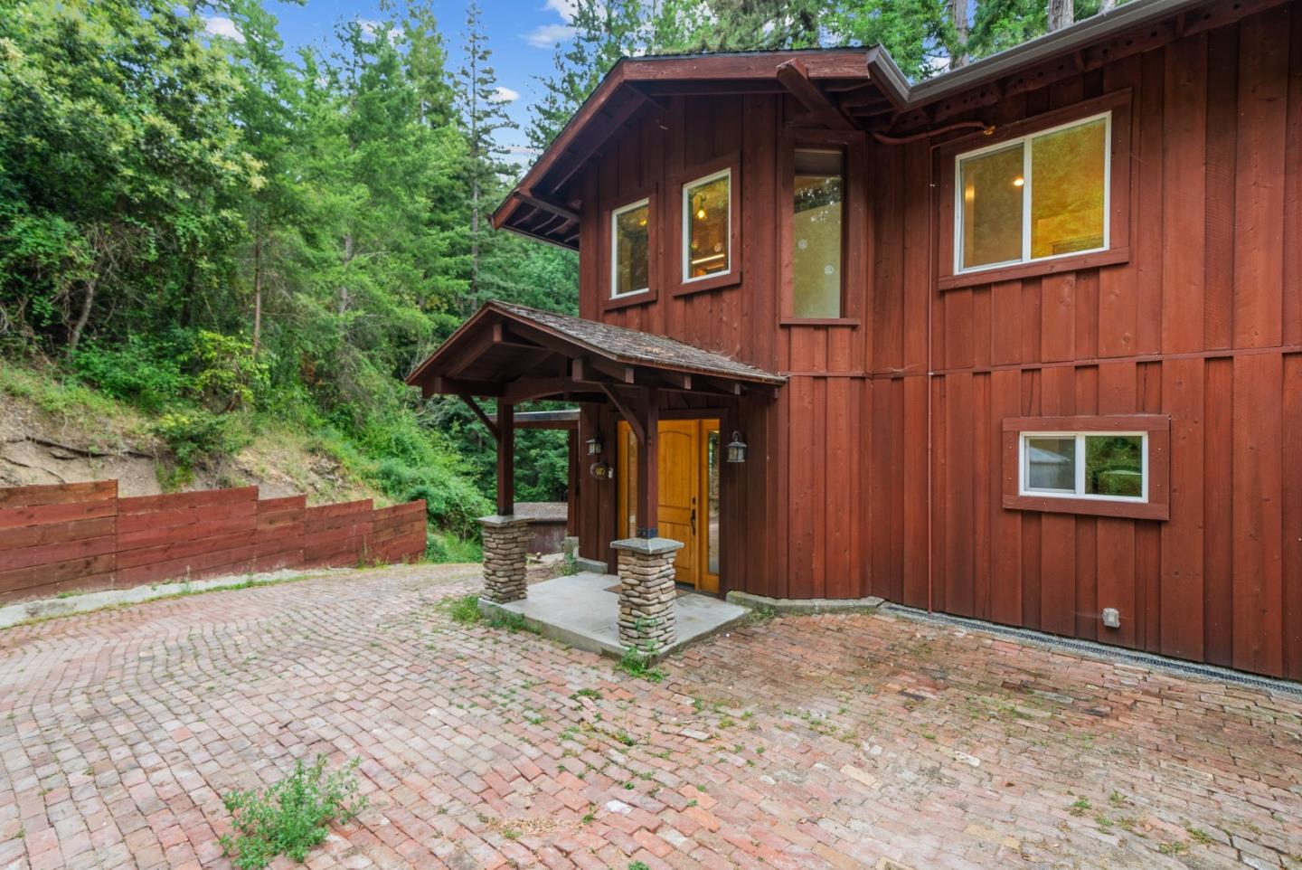 975 Logan Creek Road Boulder Creek, CA 95006 - Photo 5 of 41 a front view of a house with a yard and garage
