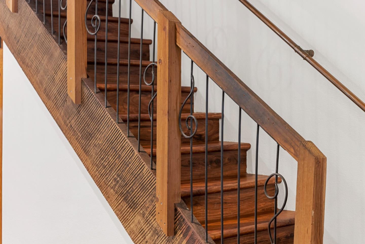 975 Logan Creek Road Boulder Creek, CA 95006 - Photo 10 of 41 a view of staircase with lots of frames on wall and a large window