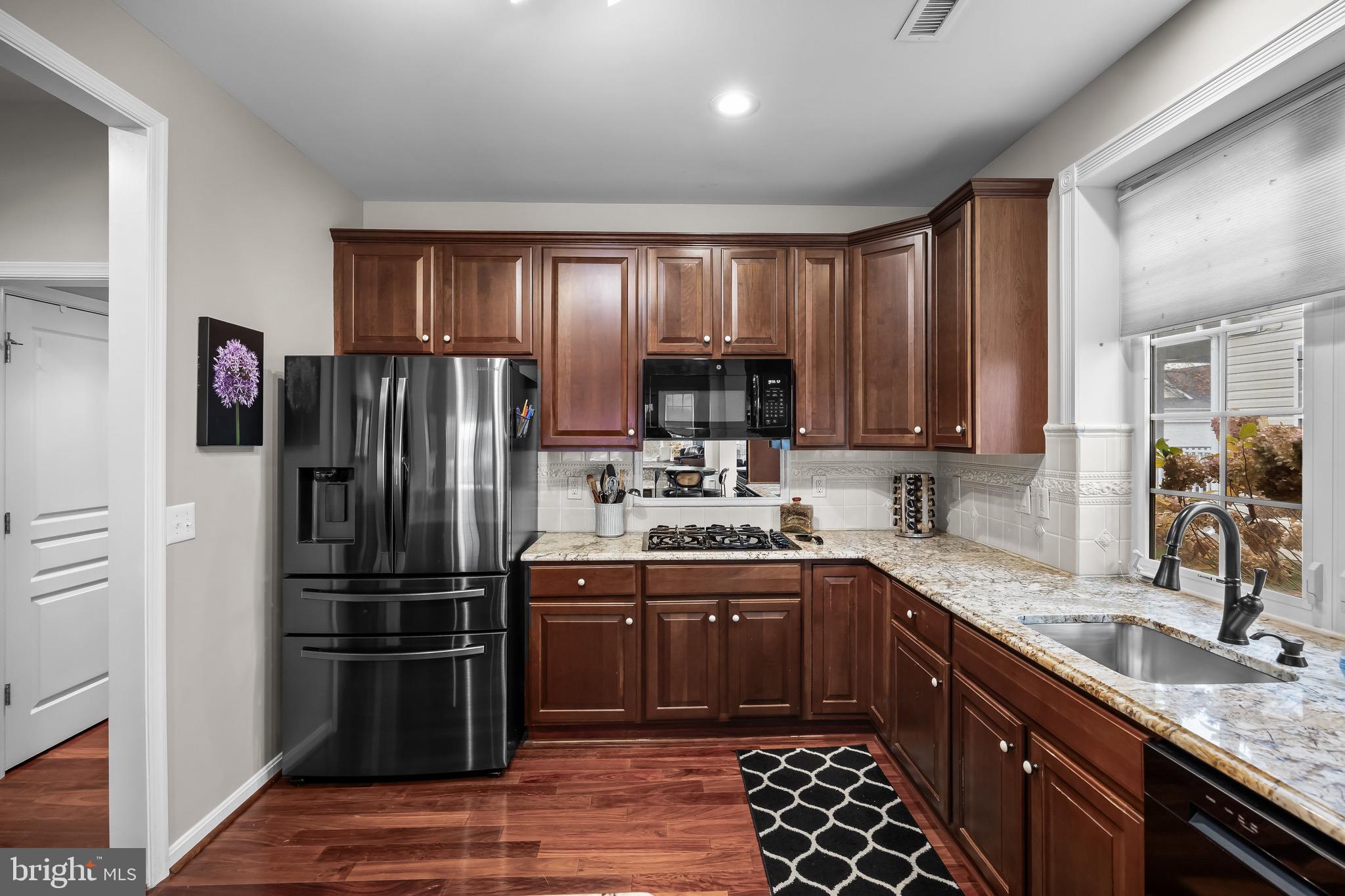 77 Pennington Court Delanco, NJ 08075 - Photo 14 of 46 a kitchen with stainless steel appliances granite countertop a sink stove and refrigerator