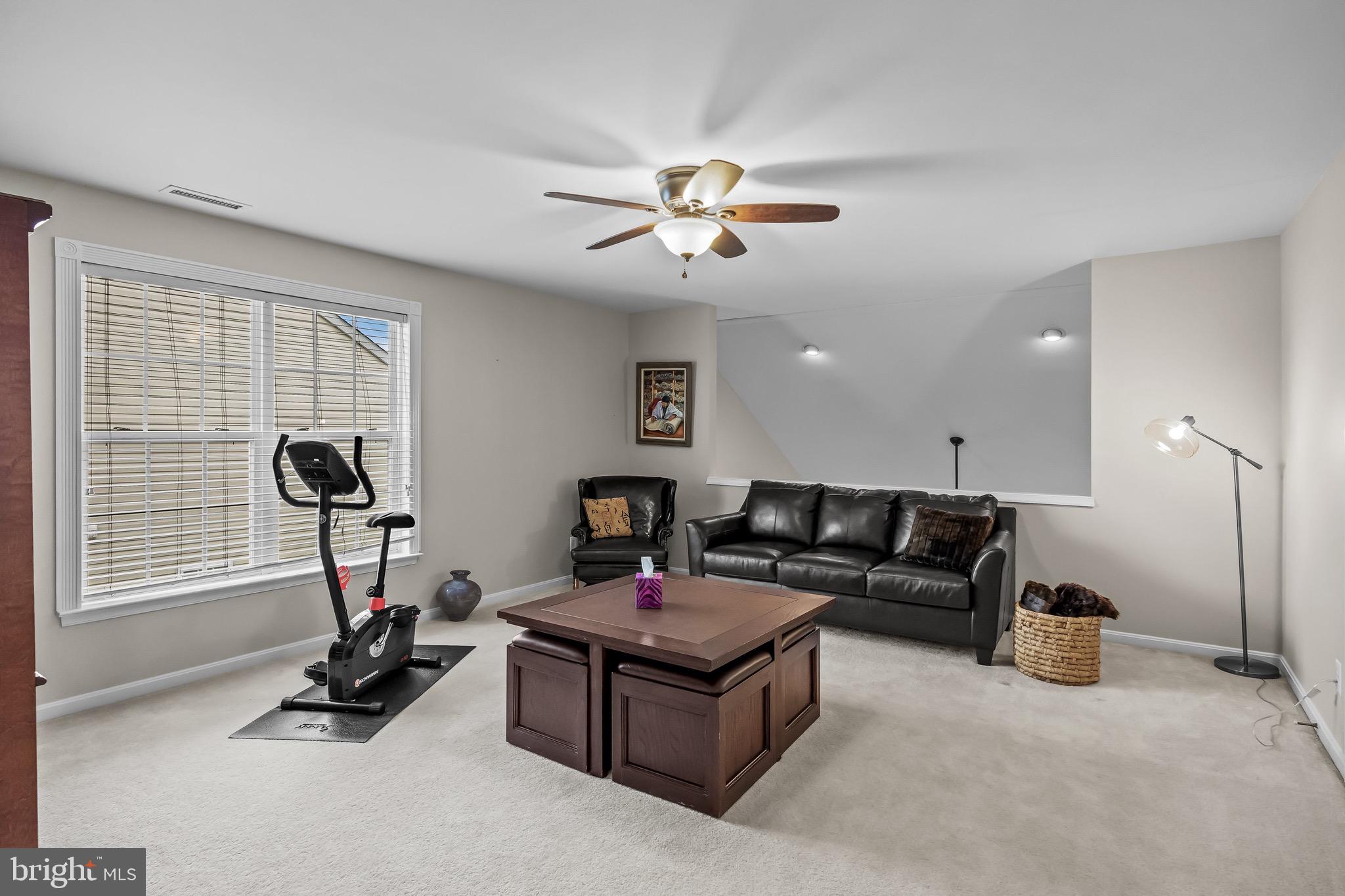 77 Pennington Court Delanco, NJ 08075 - Photo 30 of 46 a living room with furniture gym equipment and a ceiling fan