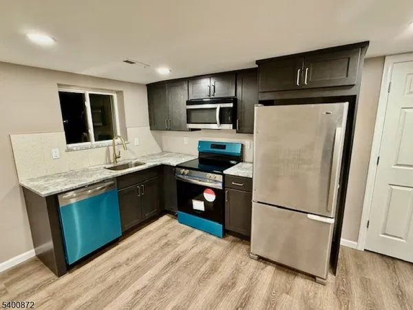 a kitchen with a refrigerator sink and microwave