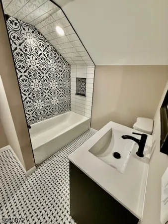 a bathroom with a bathtub and shower