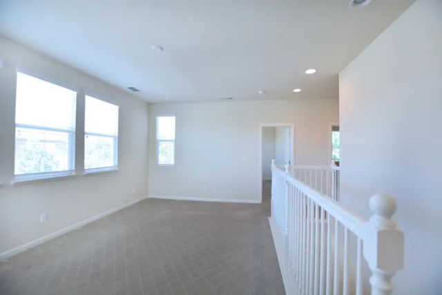 a view of an empty room with windows