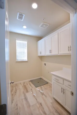 a view of a kitchen with white cabinets