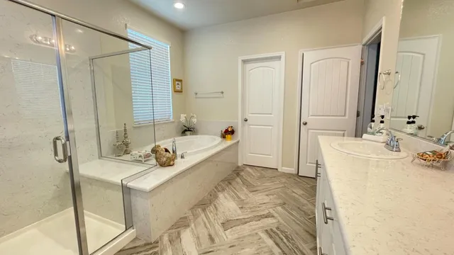 a bathroom with a tub sink and mirror