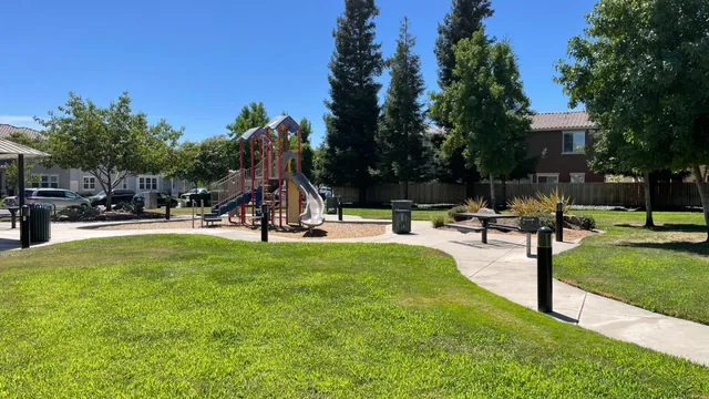 a view of a park with swings and slides