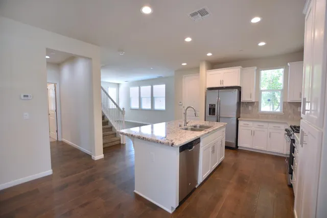 a kitchen with a sink stove and refrigerator