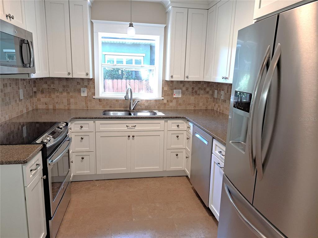 1835 Edwin Boulevard Winter Park, FL 32789 - Photo 12 of 49 a kitchen with stainless steel appliances a refrigerator sink and cabinets