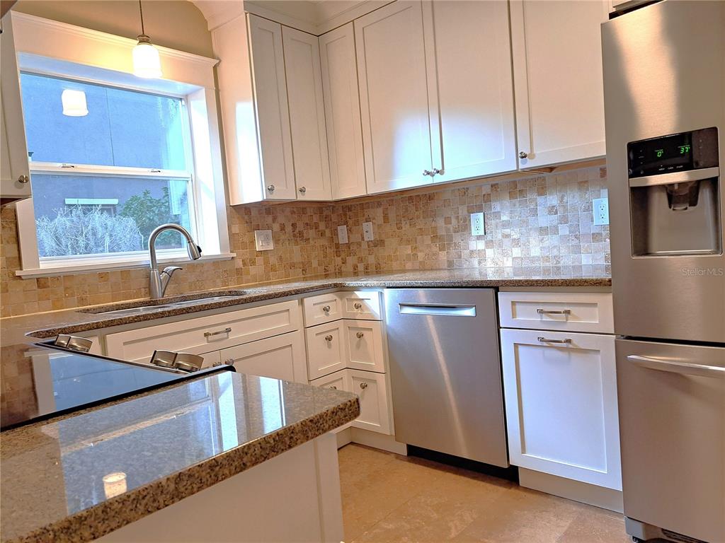 1835 Edwin Boulevard Winter Park, FL 32789 - Photo 15 of 49 a kitchen with stainless steel appliances granite countertop a refrigerator a sink and a stove