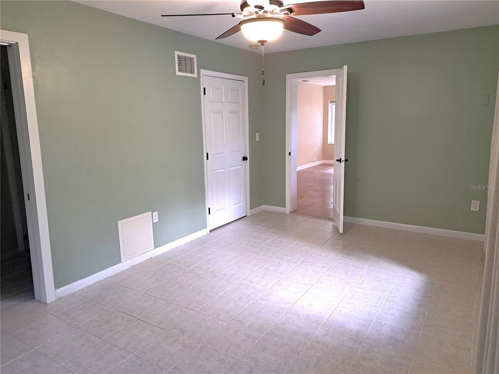 1835 Edwin Boulevard Winter Park, FL 32789 - Photo 24 of 49 an empty room with a chandelier fan and windows