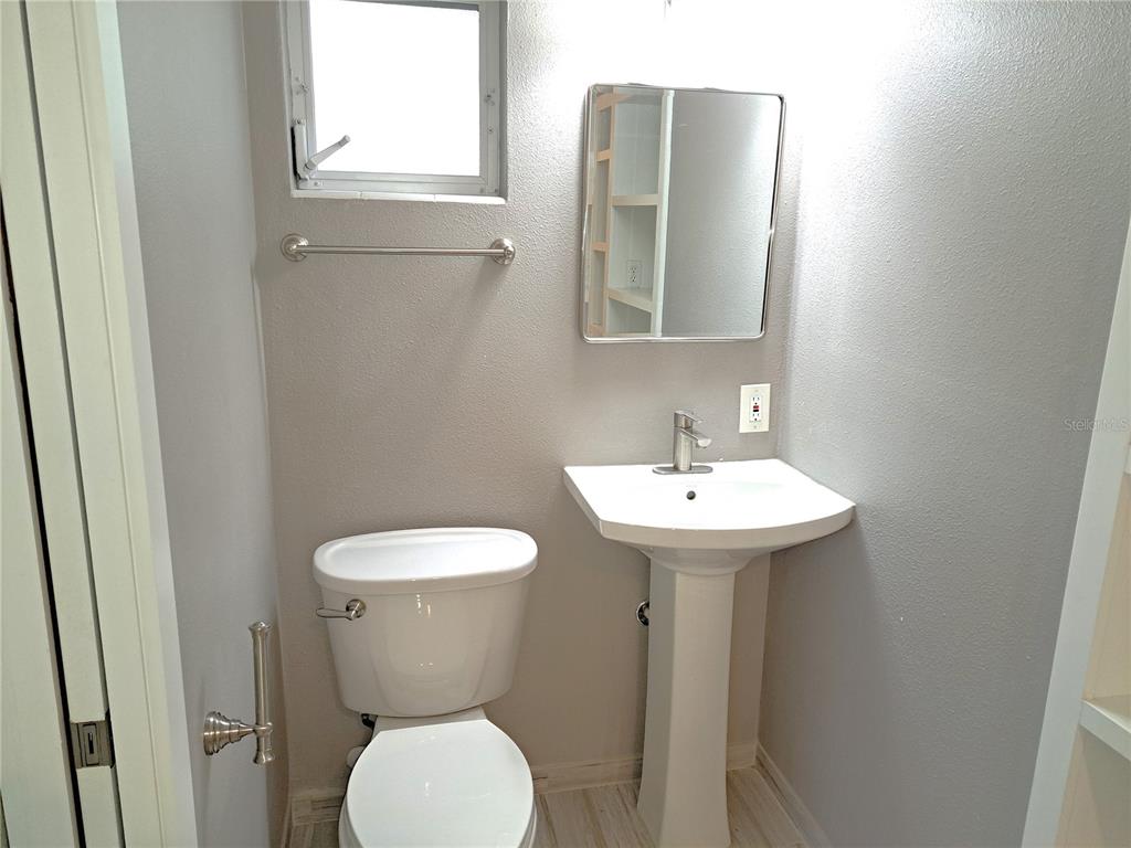 1835 Edwin Boulevard Winter Park, FL 32789 - Photo 29 of 49 a bathroom with a toilet sink and mirror