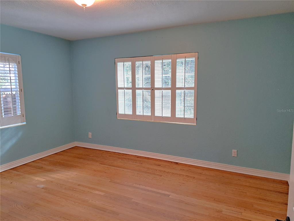 1835 Edwin Boulevard Winter Park, FL 32789 - Photo 33 of 49 a view of an empty room with wooden floor and a window