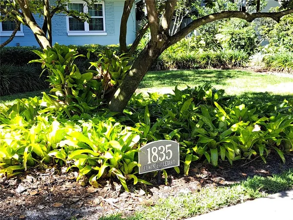 a sign that is sitting in a garden