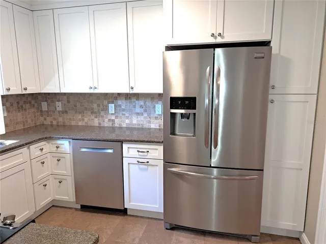 a kitchen with stainless steel appliances granite countertop a sink stove and microwave
