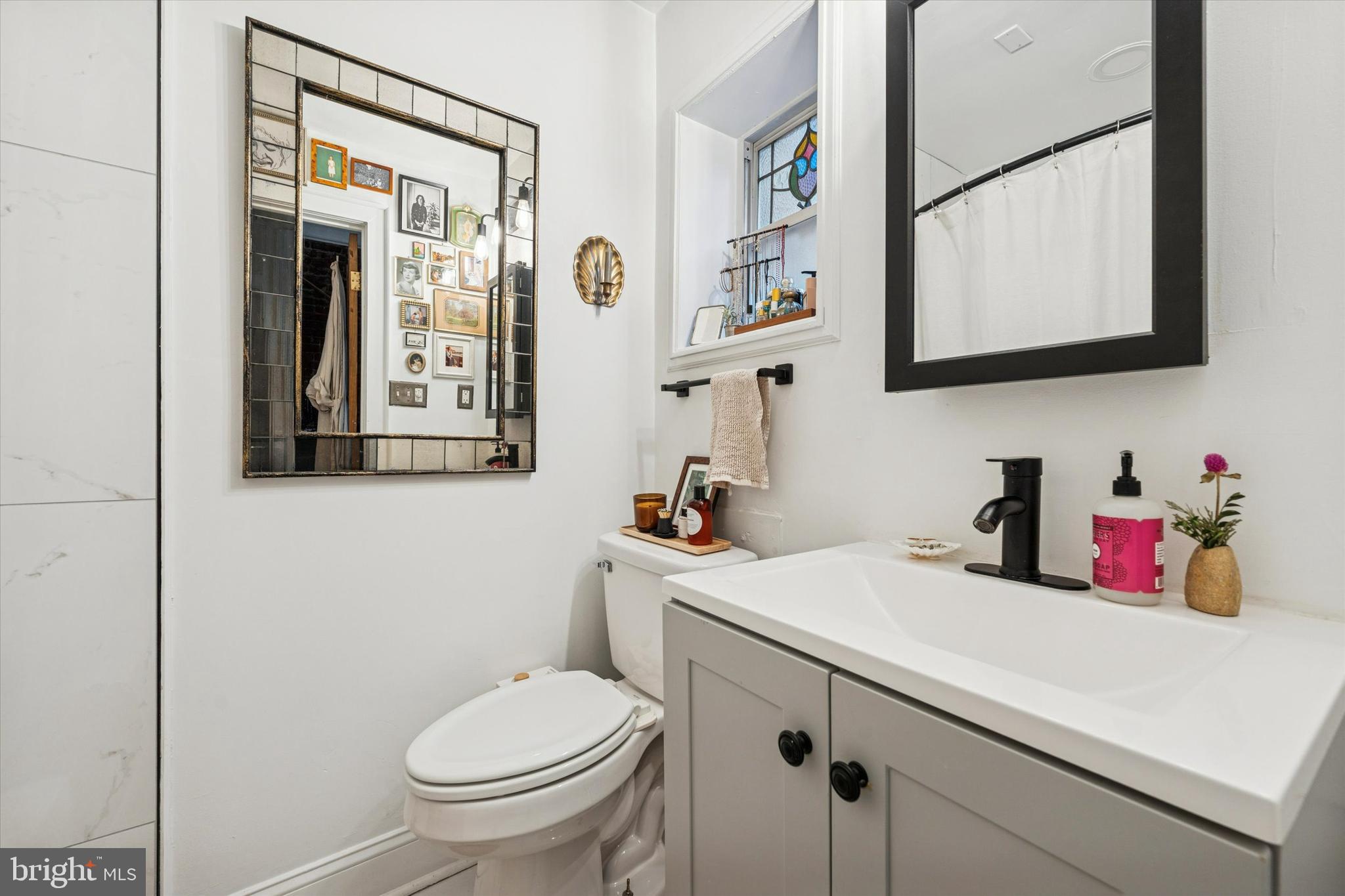 258 Quince Street Philadelphia, PA 19107 - Photo 15 of 29 a bathroom with a toilet sink and mirror
