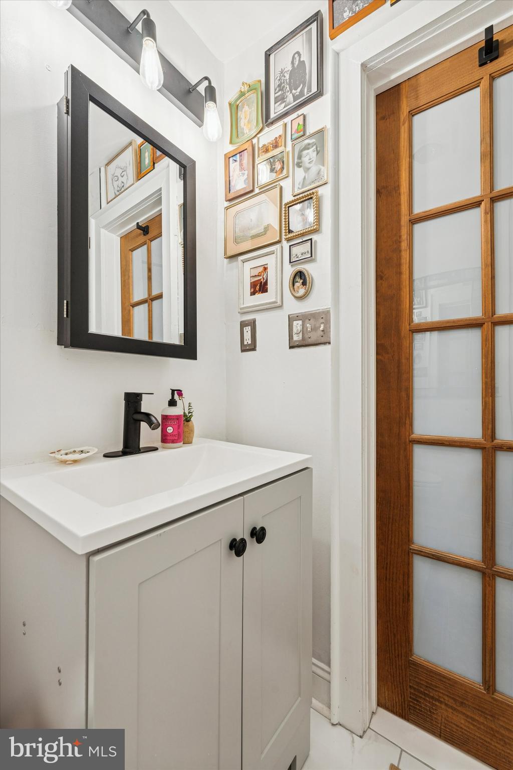 258 Quince Street Philadelphia, PA 19107 - Photo 16 of 29 a bathroom with a sink vanity and a mirror