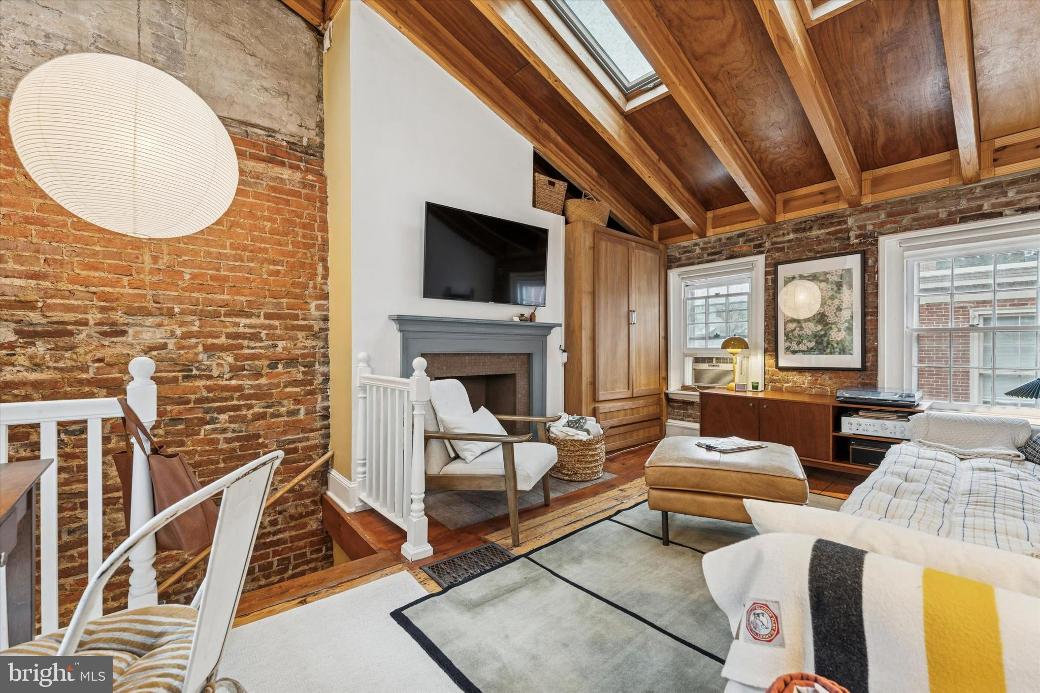 258 Quince Street Philadelphia, PA 19107 - Photo 20 of 29 a living room with couches a fireplace and a flat screen tv