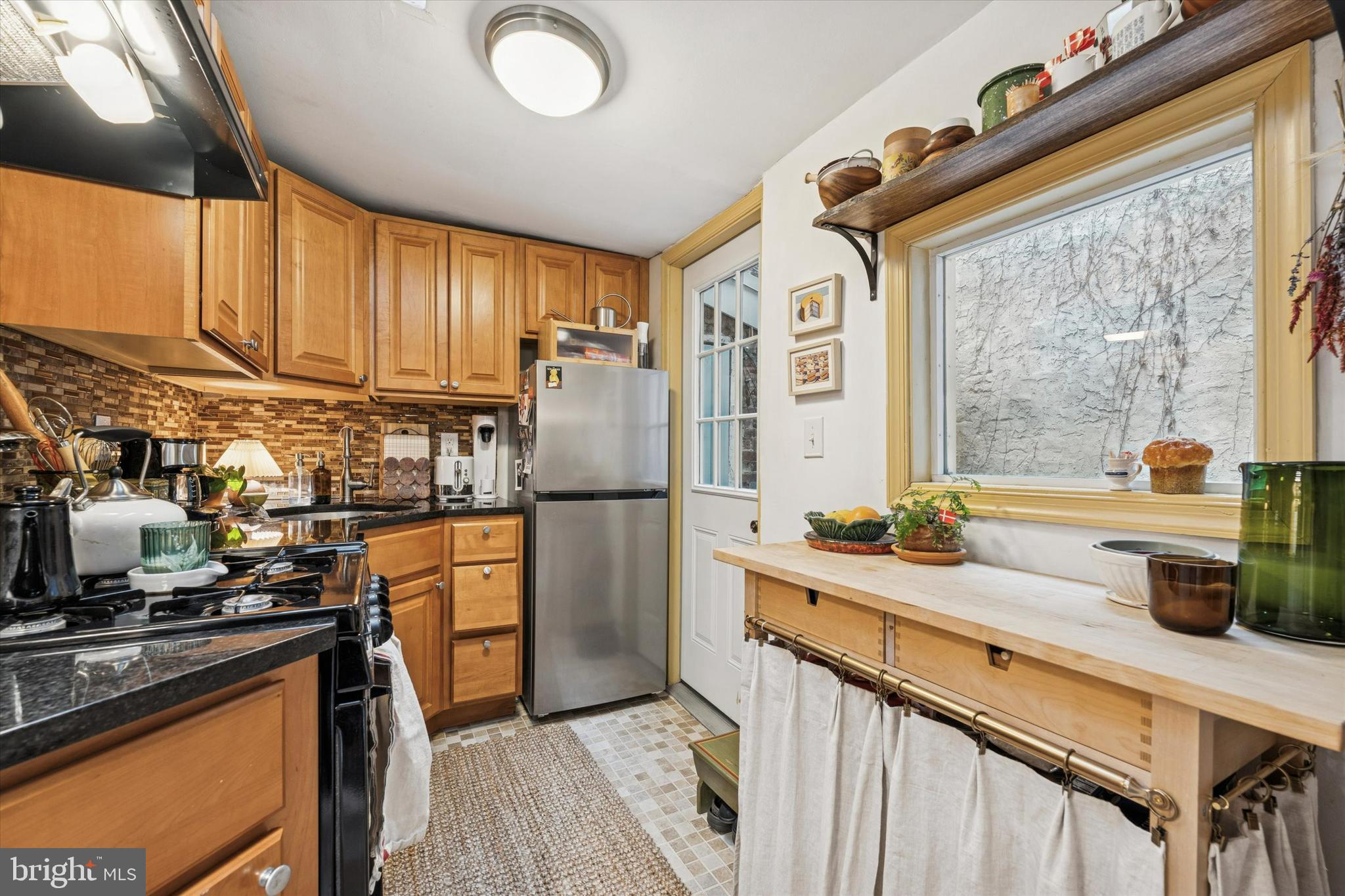 258 Quince Street Philadelphia, PA 19107 - Photo 8 of 29 a kitchen with stainless steel appliances a refrigerator a sink a stove and white cabinets