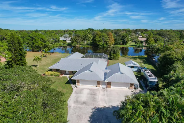 an aerial view of a house with a yard
