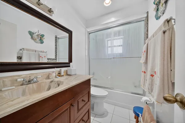 a bathroom with a sink mirror toilet and shower