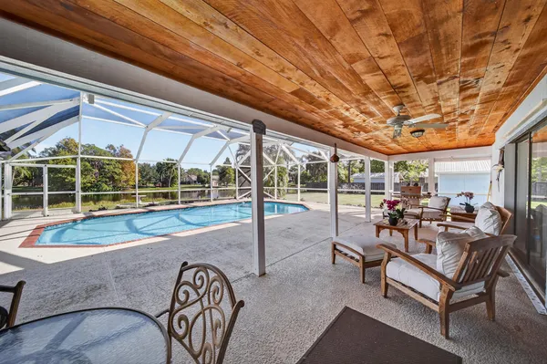 a view of a house with pool and sitting area