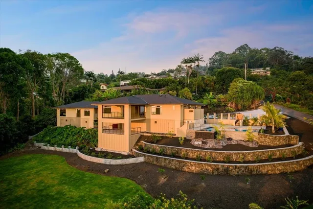 a view of a house with a yard fire pit and outdoor seating
