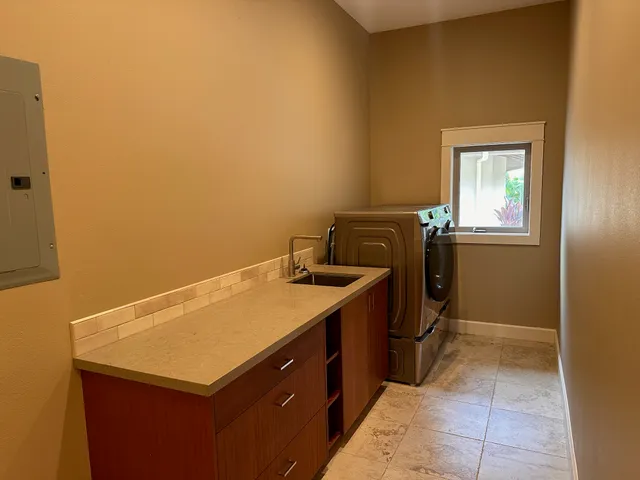 a bedroom with a bed and a dresser next to a window
