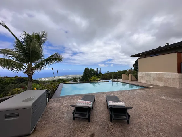 a view of a balcony with two chairs and a table