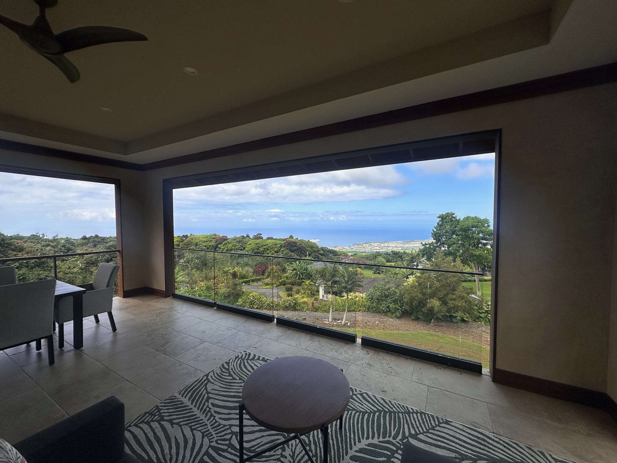 75-2620 Keopu Lani Road Holualoa, HI 96725 - Photo 6 of 30 a view of a balcony with furniture and a floor to ceiling window